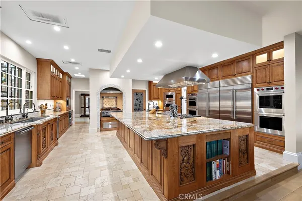 a living room with a stove and a refrigerator