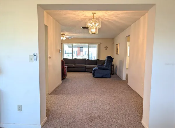 a living room with furniture and a lamp