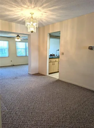 a kitchen with a refrigerator sink and cabinets