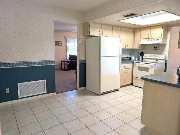 a kitchen with stainless steel appliances a sink and cabinets
