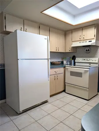a kitchen with white cabinets and a sink