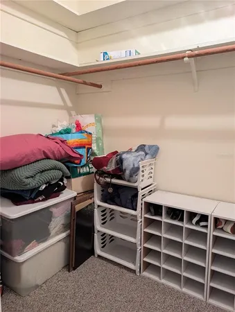 a view of a bedroom with a bed and dresser