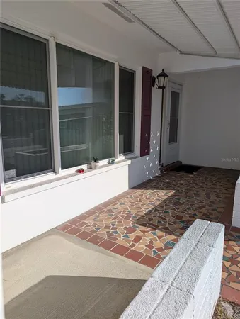 a view of a livingroom with a flesh screen tv and wooden floor