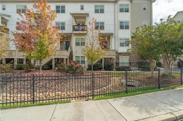 a view of a brick building next to a yard