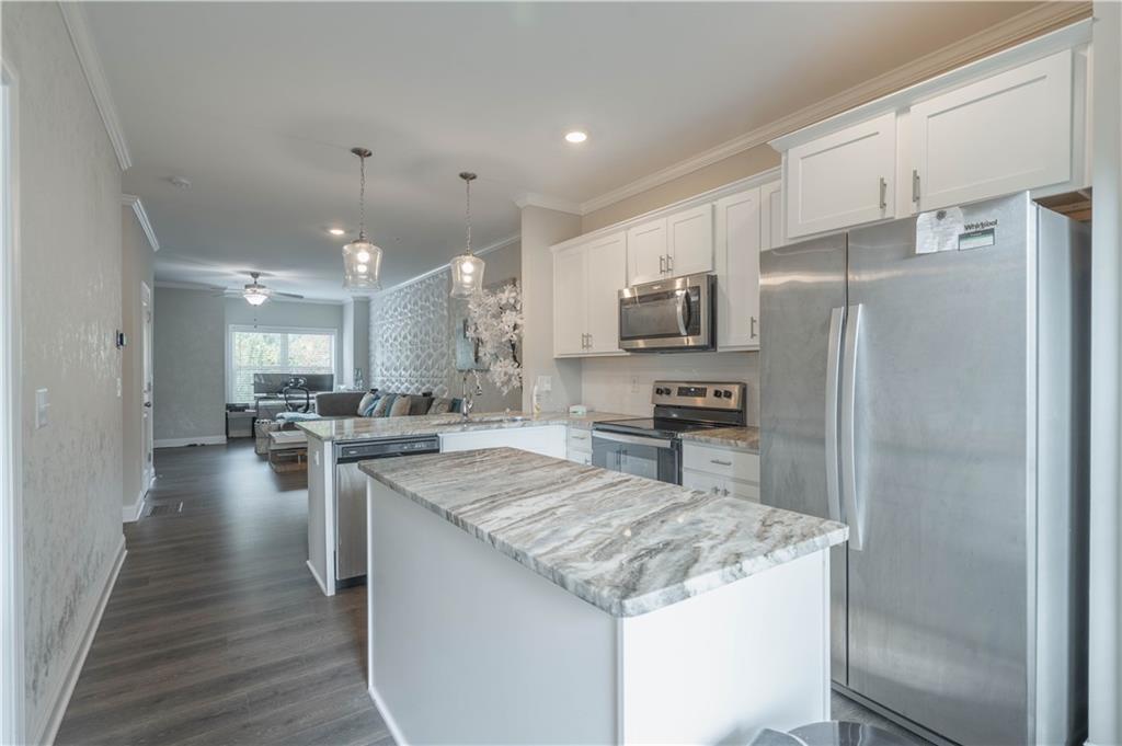 3110 Quantum Lane, Unit 53 Atlanta, GA 30341 - Photo 12 of 38 a kitchen with a sink a counter top stainless steel appliances and cabinets