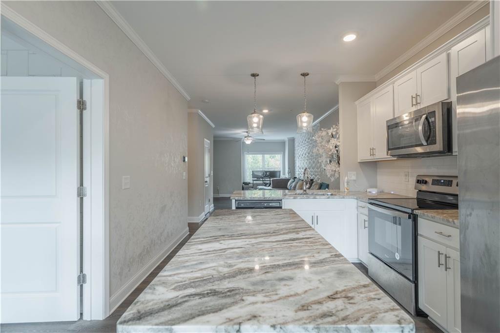 3110 Quantum Lane, Unit 53 Atlanta, GA 30341 - Photo 13 of 38 a large kitchen with stainless steel appliances lots of counter space and a sink
