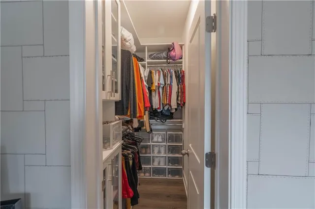 a view of walk in closet with clothes