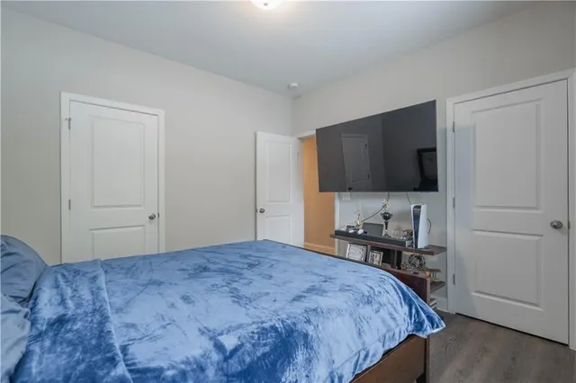 a bedroom with a bed and a flat screen tv