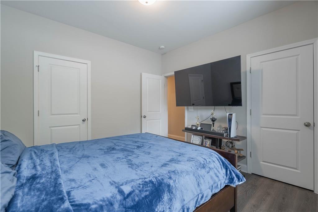 3110 Quantum Lane, Unit 53 Atlanta, GA 30341 - Photo 24 of 38 a bedroom with a bed and a flat screen tv