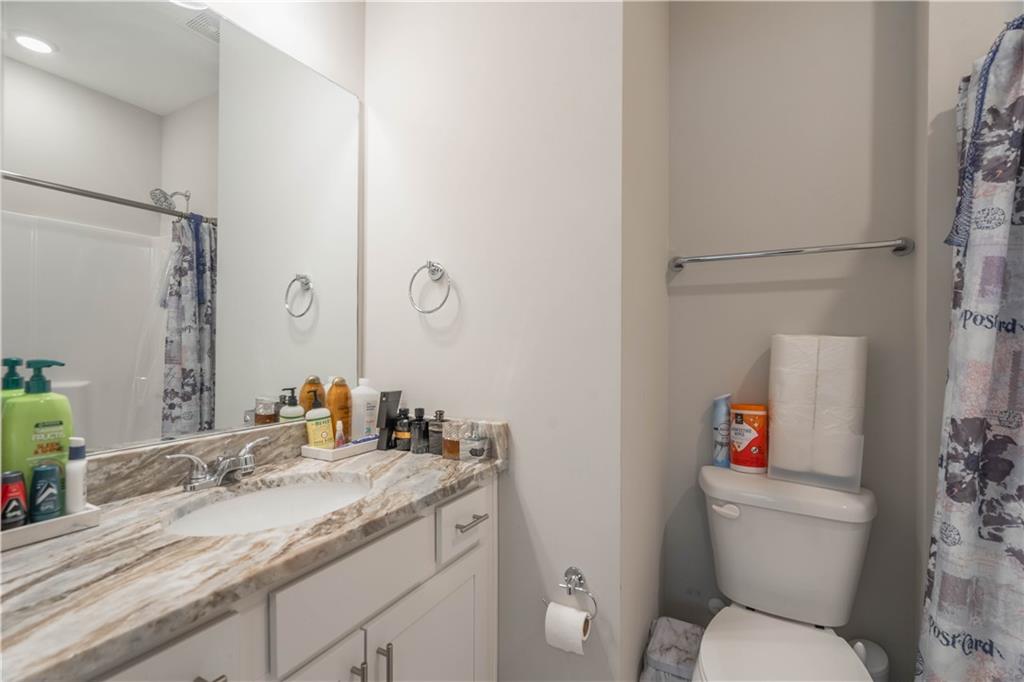 3110 Quantum Lane, Unit 53 Atlanta, GA 30341 - Photo 28 of 38 a bathroom with a granite countertop toilet sink and a mirror