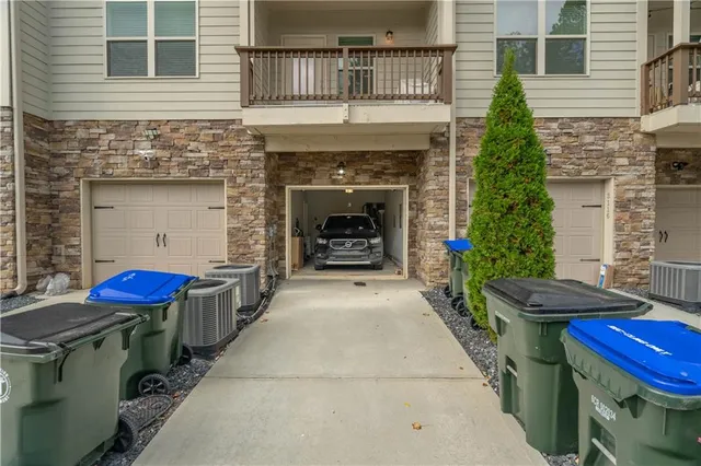 a view of a house with a fire pit and outdoor seating