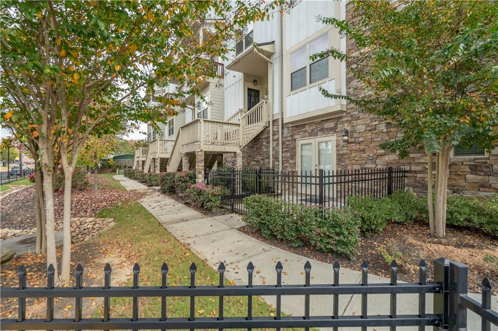 3110 Quantum Lane, Unit 53 Atlanta, GA 30341 - Photo 37 of 38 a view of a brick house with large windows and a table and chairs