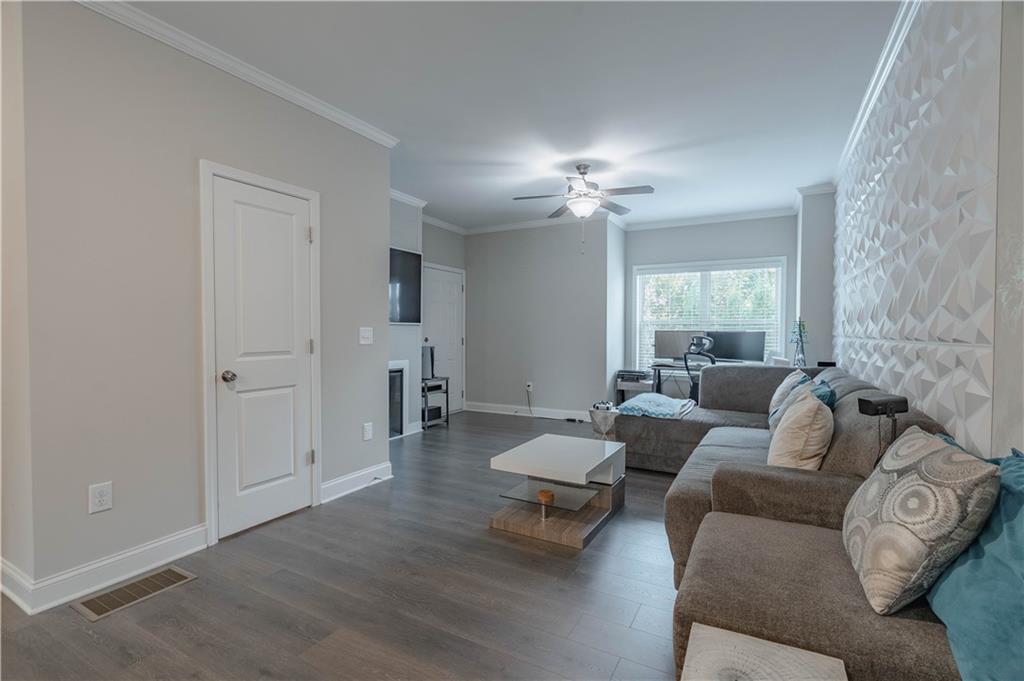 3110 Quantum Lane, Unit 53 Atlanta, GA 30341 - Photo 5 of 38 a living room with furniture and a chandelier