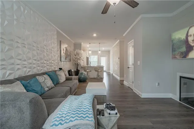 a living room with furniture and a wooden floor