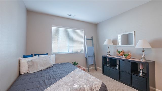 a bedroom with bed and window