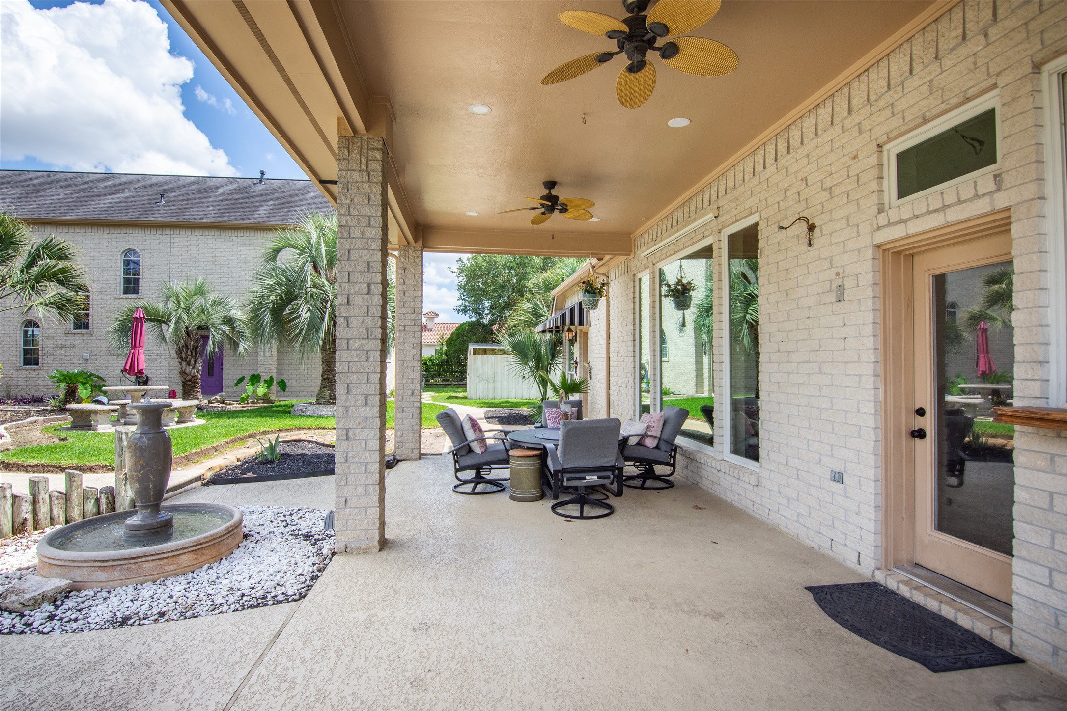13914 Skinner Road Cypress, TX 77429 - Photo 46 of 50 Covered patio with ceiling fans, plenty of seating space, and easy access to the backyard and pool area.
