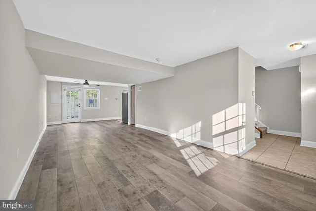 an empty space with wooden floor and windows