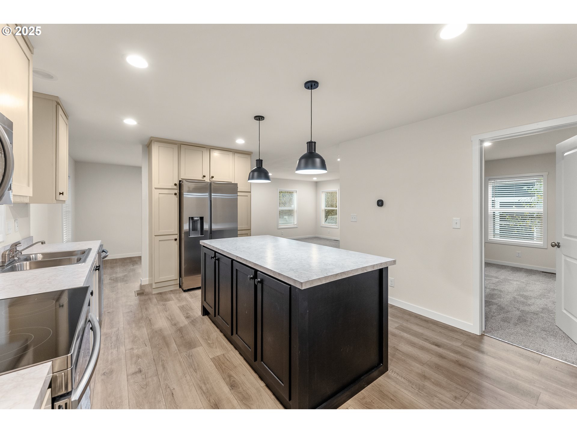 112 Twin Oaks Loop Winston, OR 97496 - Photo 11 of 35 a kitchen with stainless steel appliances granite countertop a sink a stove and a wooden floors