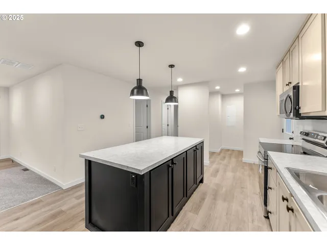 a kitchen with a sink a refrigerator and a stove