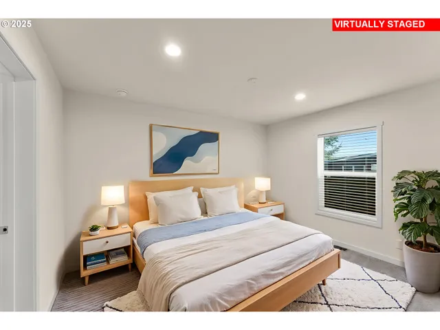 a bedroom with a bed and a potted plant