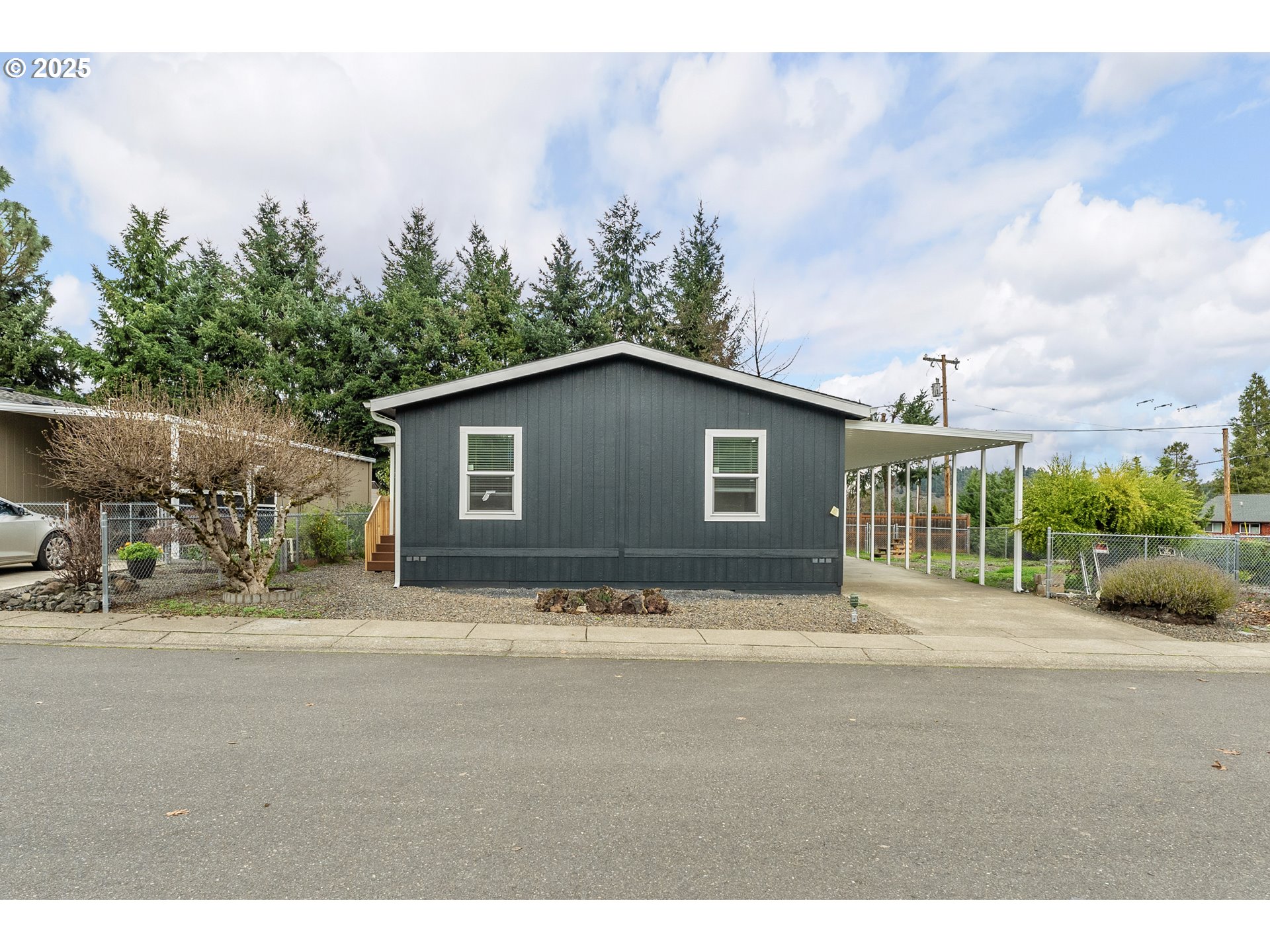 112 Twin Oaks Loop Winston, OR 97496 - Photo 2 of 35 a backyard of a house with wooden fence