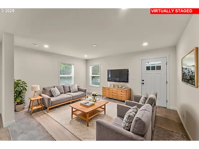 a living room with furniture and a flat screen tv