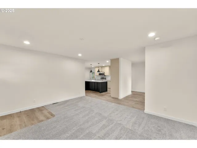 a view of a kitchen with a sink and a refrigerator