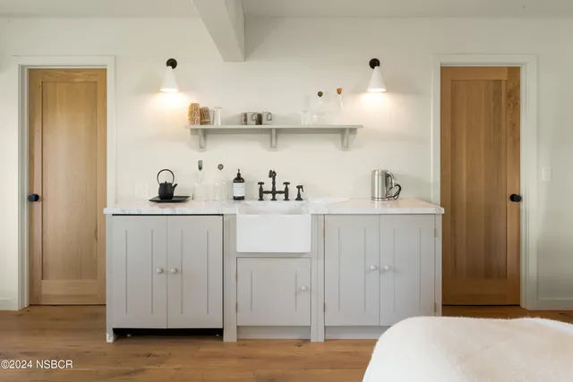 a bedroom with a bed and cabinets