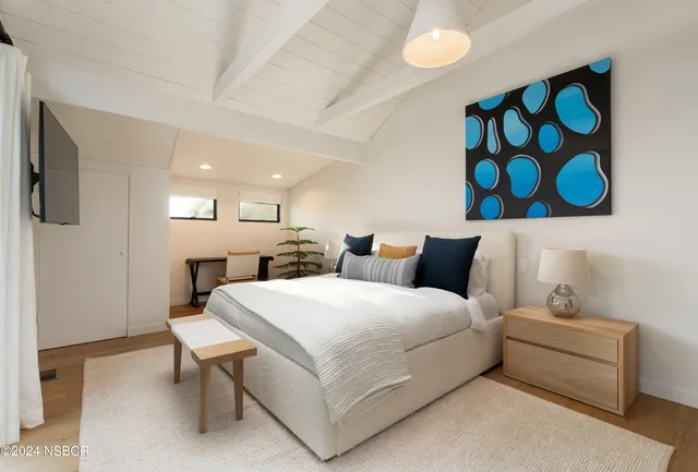 a bed room with a bed and a chair