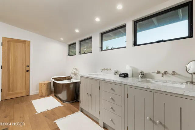 a spacious bathroom with a granite countertop sink mirror and toilet