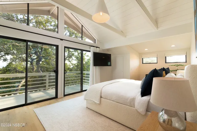 a bedroom with a large bed and a large window