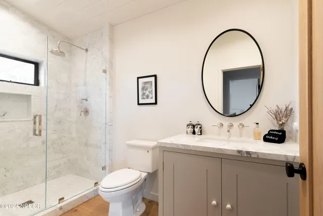 a bathroom with a toilet sink and a mirror