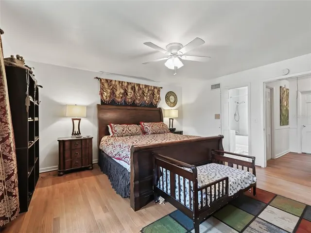 a bedroom with a bed and a table chair