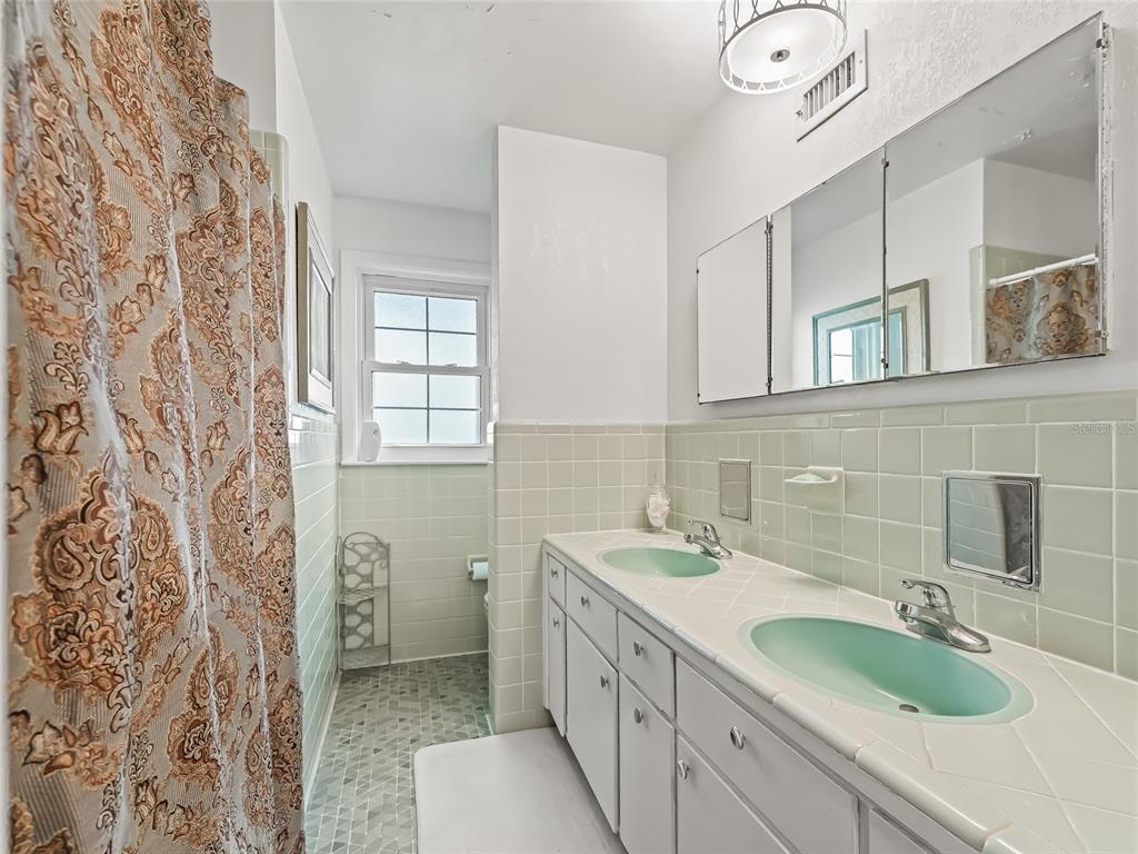 6994 Northwest Highway 320 Micanopy, FL 32667 - Photo 20 of 45 a bathroom with a granite countertop sink and a mirror