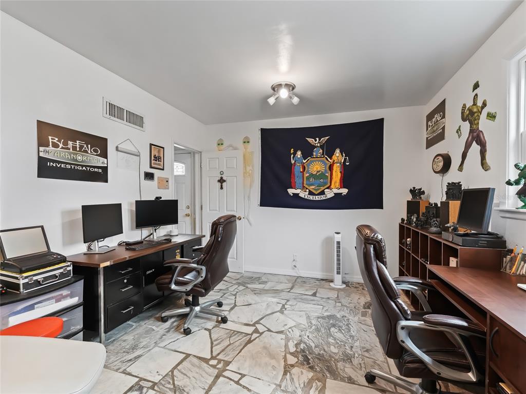6994 Northwest Highway 320 Micanopy, FL 32667 - Photo 25 of 45 a view of a workspace with furniture and wooden floor