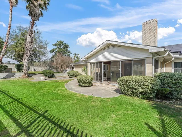 a backyard of a house with table and chairs