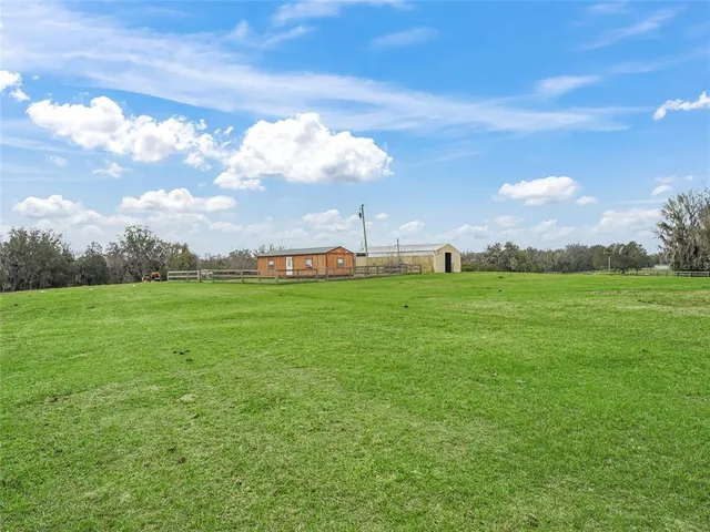 a kitchen with kitchen island stainless steel appliances a table chairs and a refrigerator