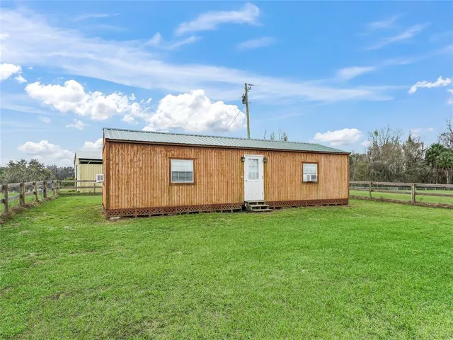 a very nice looking room with kitchen view and a flat screen tv