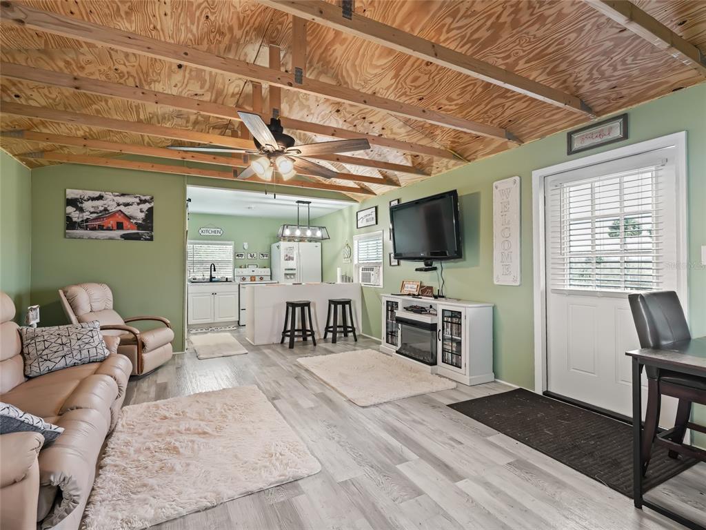 6994 Northwest Highway 320 Micanopy, FL 32667 - Photo 36 of 45 a living room with furniture and a flat screen tv