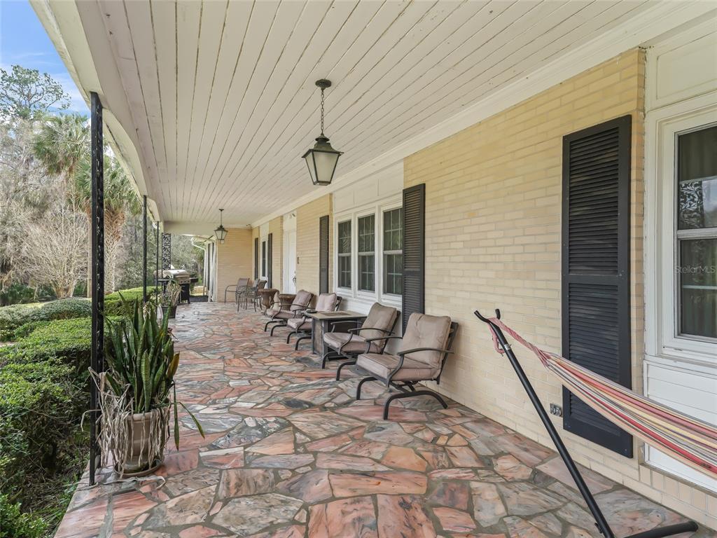 6994 Northwest Highway 320 Micanopy, FL 32667 - Photo 8 of 45 a view of a patio with chairs and tables