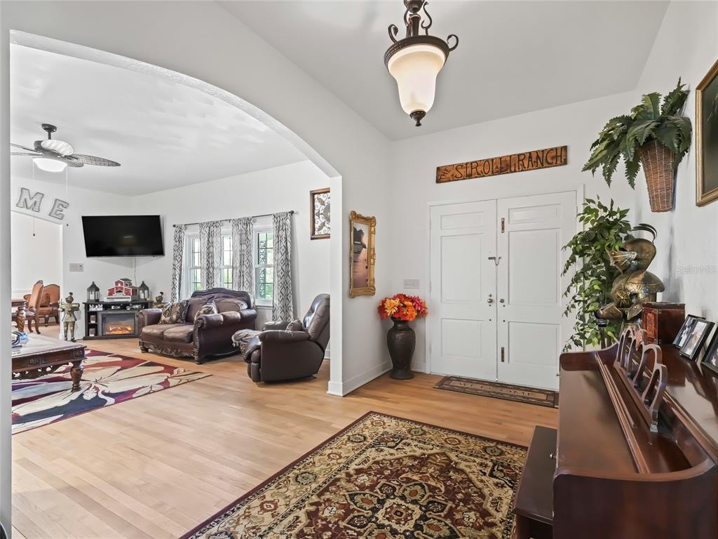 6994 Northwest Highway 320 Micanopy, FL 32667 - Photo 9 of 45 a living room with furniture and a flat screen tv