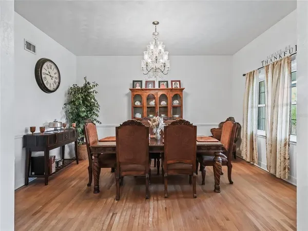 a kitchen with stainless steel appliances a sink a stove a refrigerator cabinets and a window