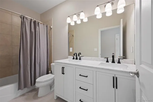 a view of a room with window a ceiling fan and refrigerator