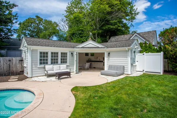 a house view with a sitting space and garden