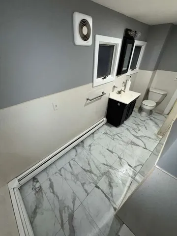 a view of bathroom with a sink and mirror