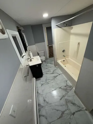 a bathroom with a sink mirror toilet and shower