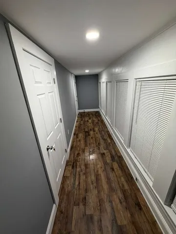 a view of a hallway and wooden floor