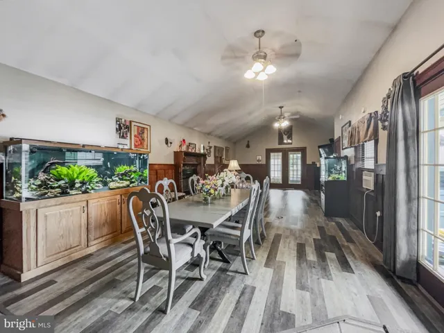 a view of a dining room with furniture and a potted plant