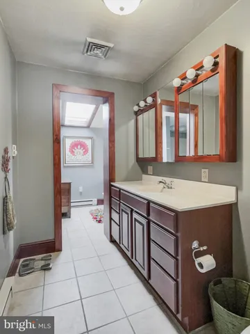 a bathroom with a sink a vanity and a mirror