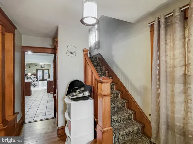 a view of hallway with wooden floor and stairs